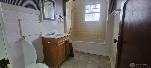 bathroom featuring toilet, tile patterned floors, tub / shower combination, and vanity