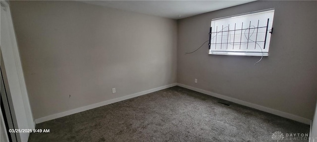 carpeted spare room with baseboards and visible vents