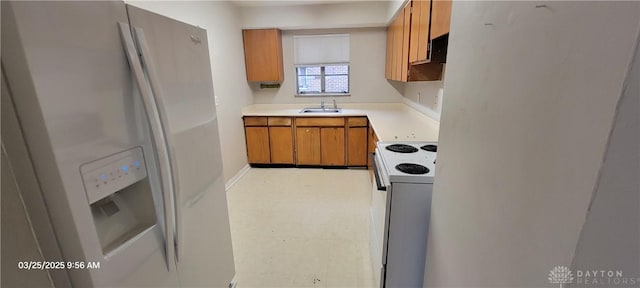 kitchen with white appliances, light floors, a sink, light countertops, and brown cabinets