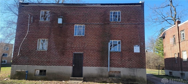 view of side of home featuring brick siding