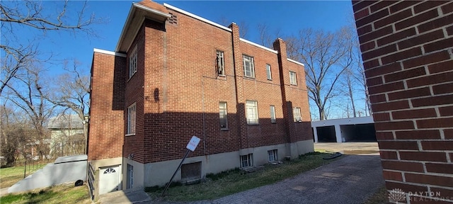 view of side of home with brick siding