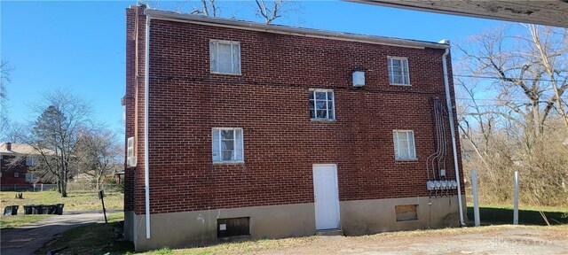 view of side of home featuring brick siding