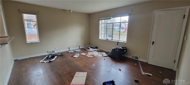 interior space with visible vents, wood finished floors, and multiple windows