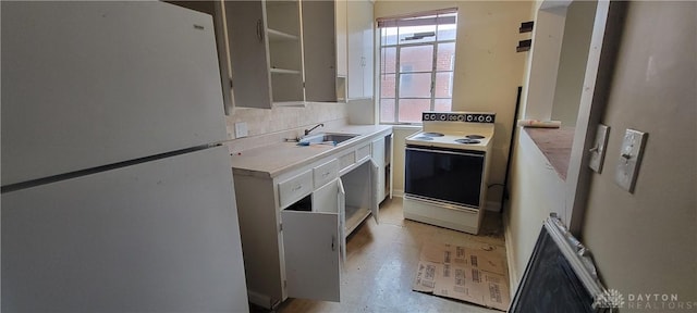 kitchen featuring tasteful backsplash, open shelves, a sink, light countertops, and white appliances