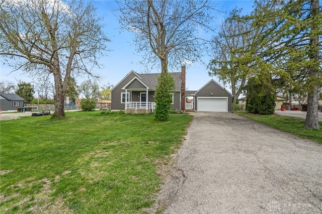 ranch-style home with a front yard, an attached garage, covered porch, and driveway