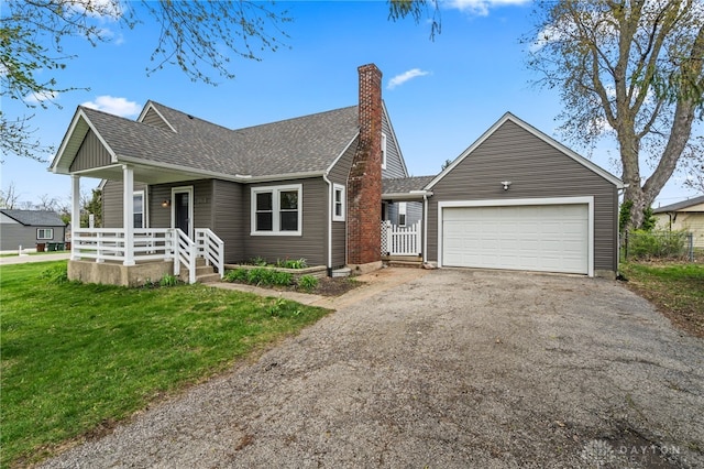 view of front of property with aphalt driveway, covered porch, a front yard, an attached garage, and a shingled roof