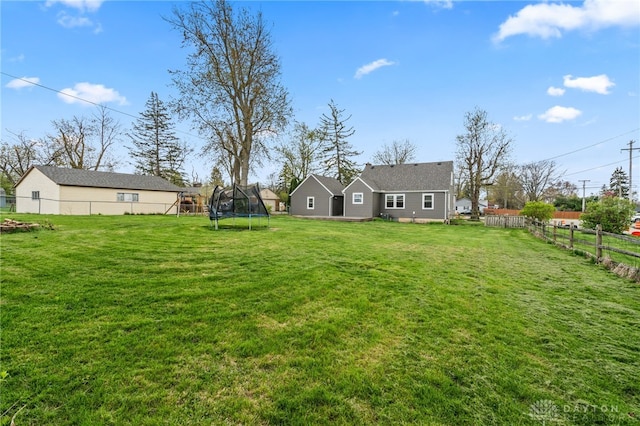 view of yard with a fenced backyard and a trampoline