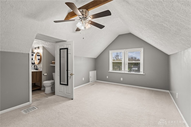 bonus room with visible vents, ceiling fan, carpet floors, and a textured ceiling