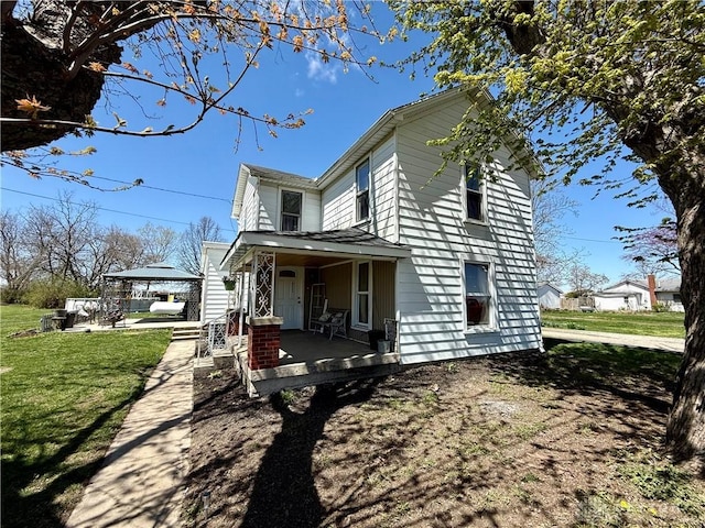 view of property exterior featuring a lawn, a gazebo, and covered porch