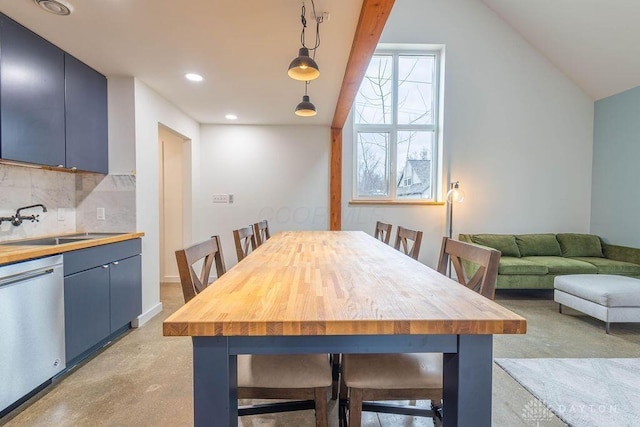 dining room featuring lofted ceiling, finished concrete floors, and recessed lighting