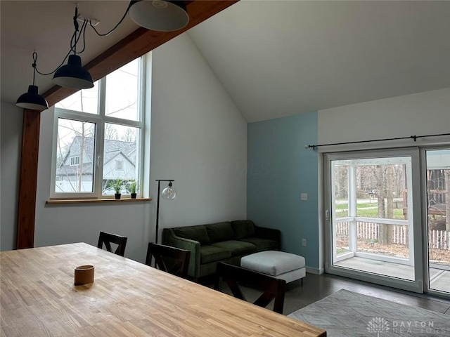 dining room with lofted ceiling and baseboards