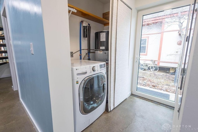 clothes washing area with washer / dryer, water heater, a healthy amount of sunlight, and laundry area