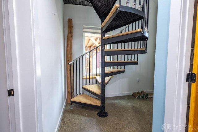 stairway featuring baseboards