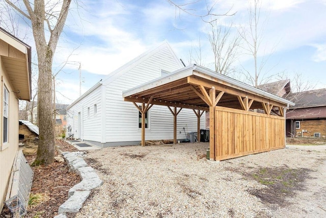 exterior space with gravel driveway and a detached carport