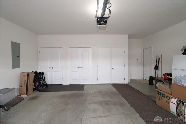 garage with electric panel and a garage door opener