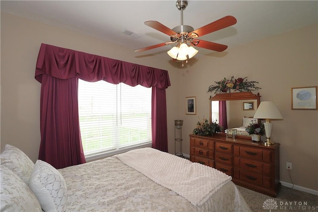 bedroom featuring carpet floors, visible vents, a ceiling fan, and baseboards