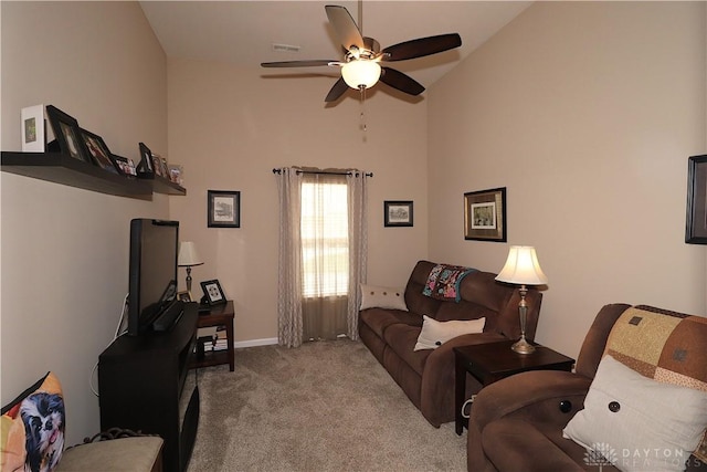 living room featuring a ceiling fan, baseboards, carpet, and high vaulted ceiling