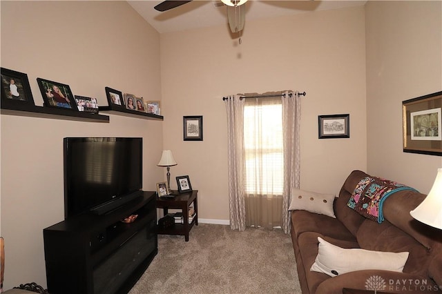 carpeted living room featuring ceiling fan and baseboards