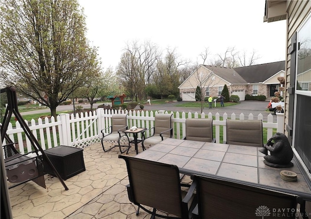 view of patio / terrace featuring outdoor dining area and fence