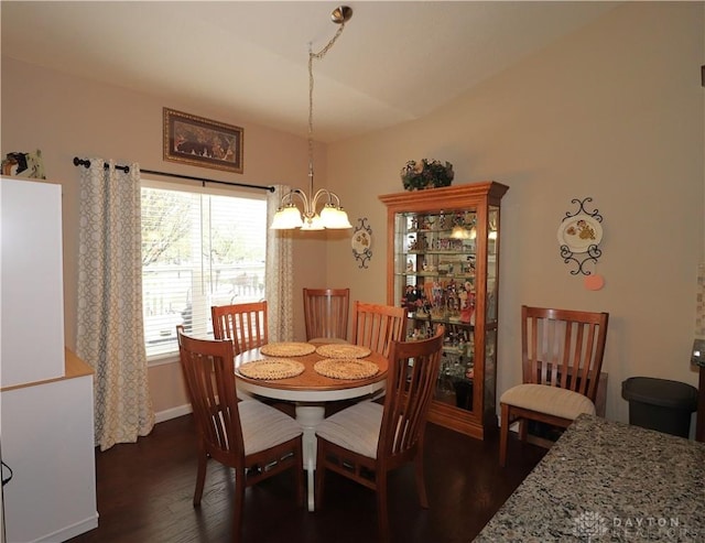 dining room with baseboards, dark wood-style floors, and a notable chandelier