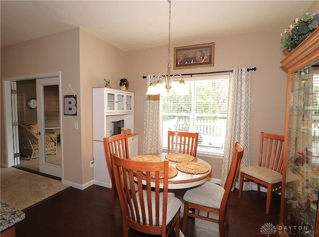 dining room with dark wood-style flooring, baseboards, a notable chandelier, and a healthy amount of sunlight