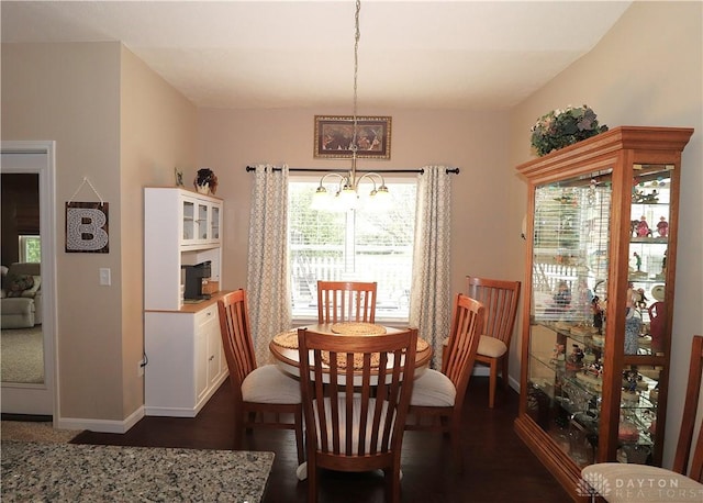 dining room featuring baseboards, a chandelier, and dark wood-type flooring