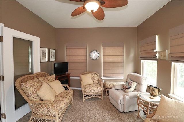 sitting room with carpet and a ceiling fan