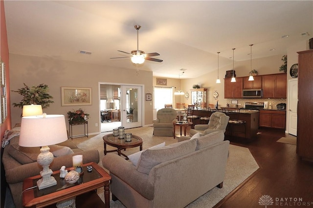 living area featuring dark wood finished floors, visible vents, and a ceiling fan