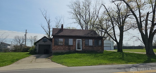 305 S Ada Doty St, Gratis, OH 45330 - bungalow-style house with brick siding, a front yard, driveway, a chimney, and a garage