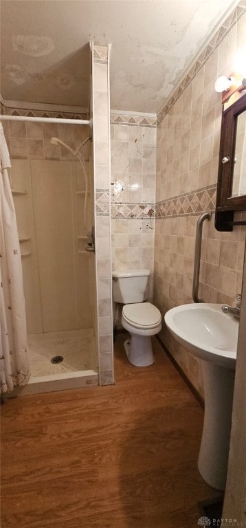 305 S Ada Doty St, Gratis, OH 45330 - full bathroom featuring tile walls, a stall shower, wood finished floors, and toilet