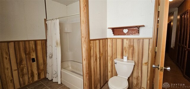305 S Ada Doty St, Gratis, OH 45330 - full bathroom with wood walls, wainscoting, toilet, shower / bath combination with curtain, and tile patterned floors