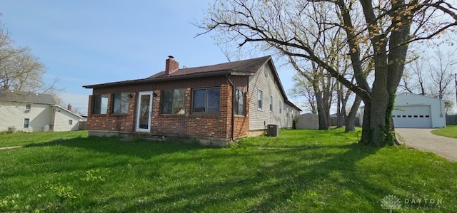 305 S Ada Doty St, Gratis, OH 45330 - view of home's exterior with a chimney, brick siding, a detached garage, a yard, and central air condition unit