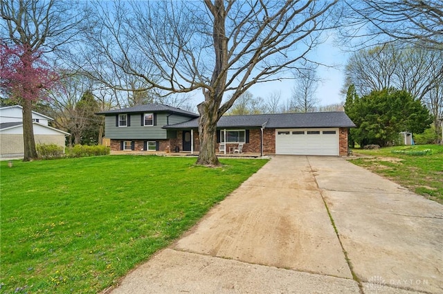 tri-level home with a front lawn, driveway, a porch, a garage, and brick siding