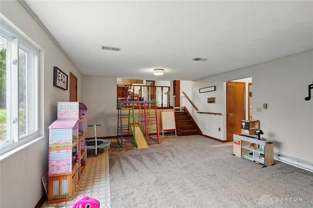 rec room featuring a wealth of natural light, carpet flooring, visible vents, and baseboards