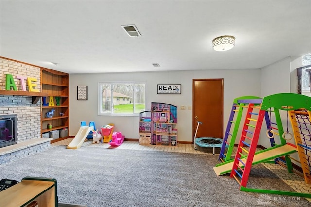 game room with built in features, a fireplace, baseboards, carpet flooring, and visible vents
