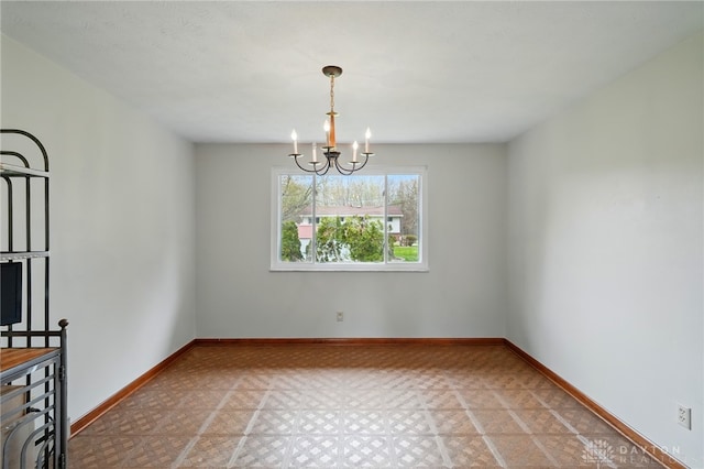 unfurnished dining area featuring light floors, baseboards, and a chandelier
