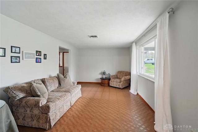 living room featuring visible vents and baseboards
