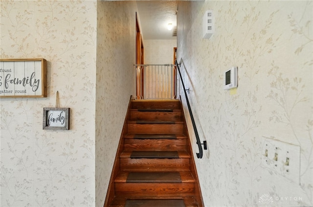 staircase featuring wallpapered walls
