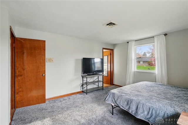 carpeted bedroom featuring baseboards and visible vents