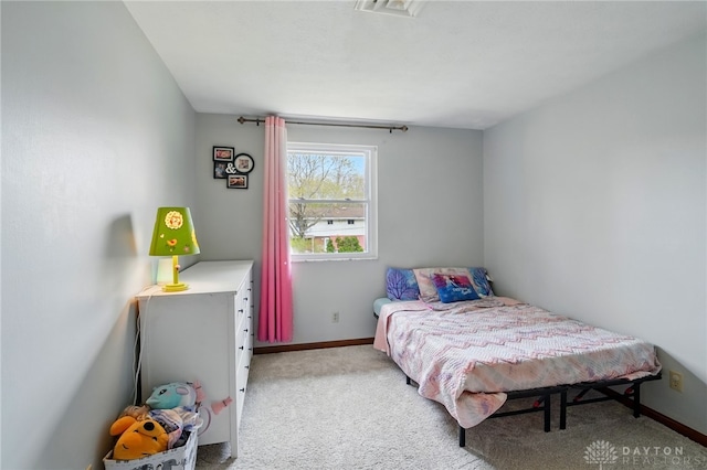 bedroom featuring light carpet and baseboards