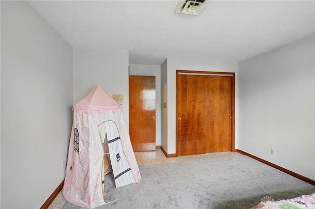 unfurnished bedroom with baseboards, carpet flooring, and visible vents
