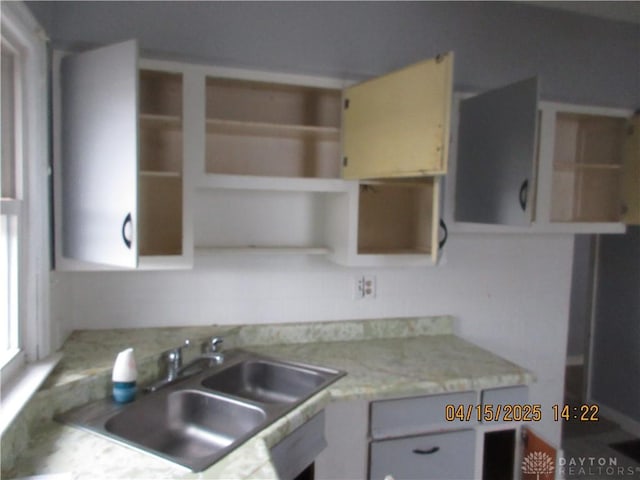 1329 Lamar Dr, Springfield, OH 45504 - kitchen featuring open shelves, light countertops, and a sink