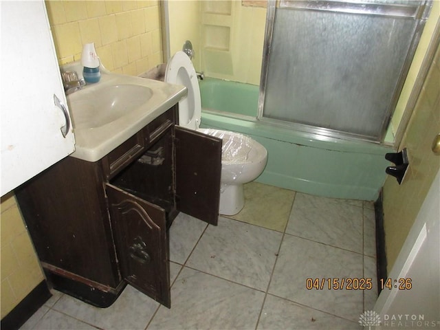 1329 Lamar Dr, Springfield, OH 45504 - full bathroom with vanity, tile patterned flooring, bath / shower combo with glass door, and toilet