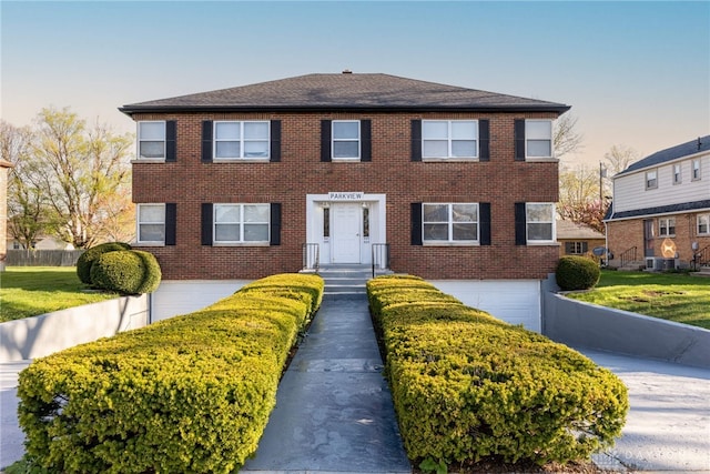 349 Orchard Dr, Oakwood, OH 45419 - colonial house with an attached garage, driveway, brick siding, and a front yard