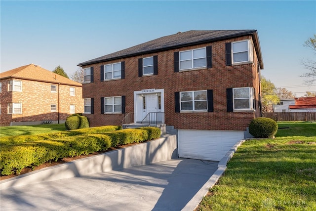 349 Orchard Dr, Oakwood, OH 45419 - colonial home featuring brick siding, an attached garage, driveway, and a front yard