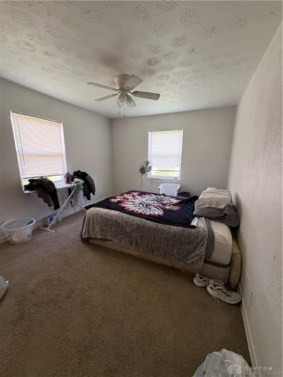 349 Orchard Dr, Oakwood, OH 45419 - bedroom with ceiling fan, carpet floors, a textured ceiling, and baseboards