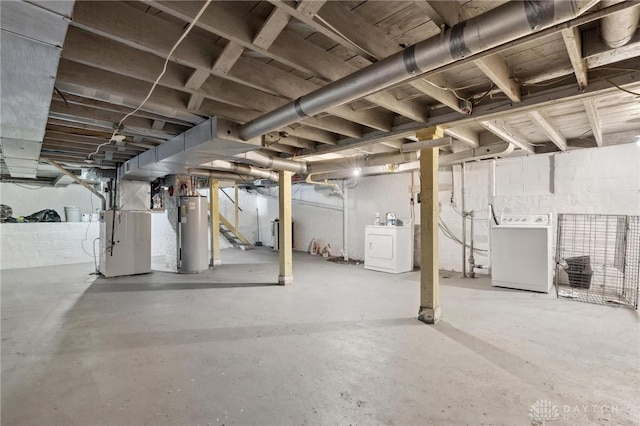 unfinished basement featuring heating unit, water heater, stairway, and washer / dryer