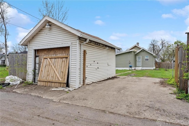 detached garage featuring fence