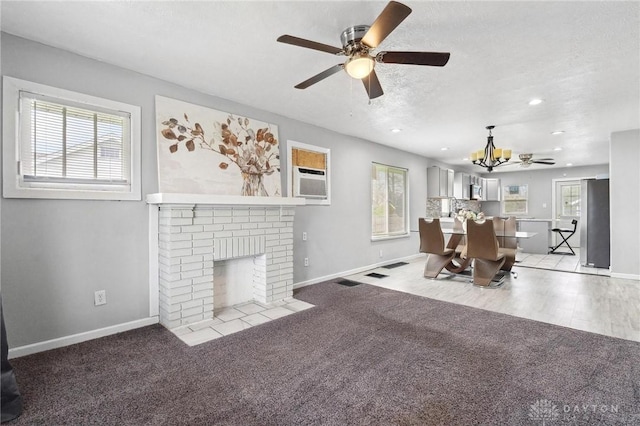 living area with recessed lighting, baseboards, and ceiling fan with notable chandelier