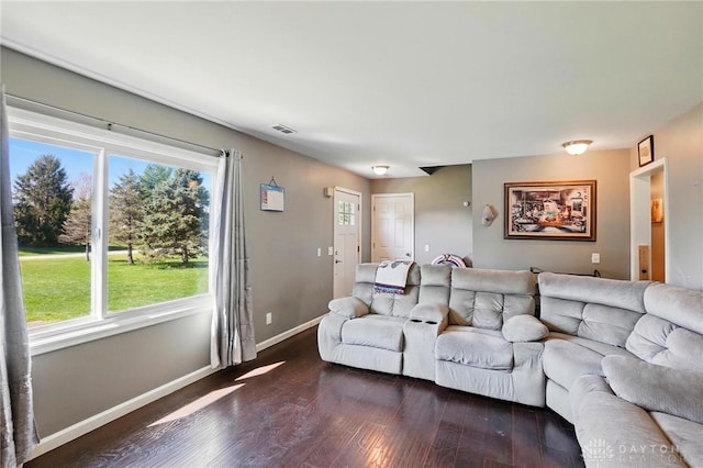 living room with baseboards, dark wood-style flooring, and visible vents